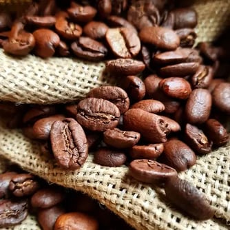 coffee beans around hessian bag. Fresh, light, dark, local, near me, delicious, best, awesome, close, brown, flavourful coffee beans around hessian bag. Fresh, light, dark, local, near me, delicious, best, awesome, close, brown, flavourful